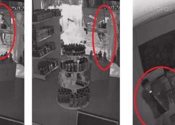 O ataque: homem se aproxima com uma pedra e arremessa contra a vidraça, que explode; a seguir, ingressa na loja com cigarro na boca e leva objetos e valores. Reprodução
