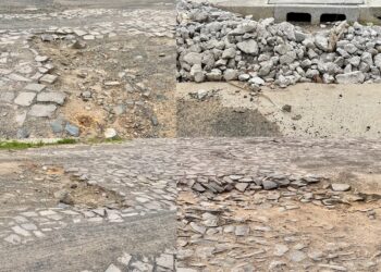 Buracos, crateras, pedras soltas, entulho... Cenário em rua no bairro Operário.